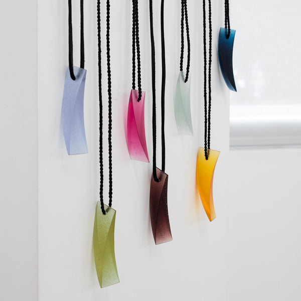Galia Amsel Cast Glass Neckpieces Hanging on Wall